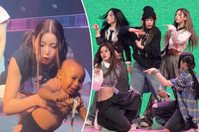 Bambino gattona sul palco al concerto del gruppo K-pop NMIXX
